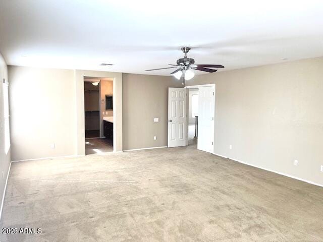 carpeted empty room featuring ceiling fan