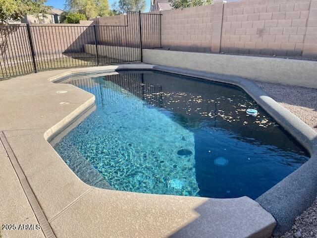 view of swimming pool featuring a fenced backyard and a fenced in pool