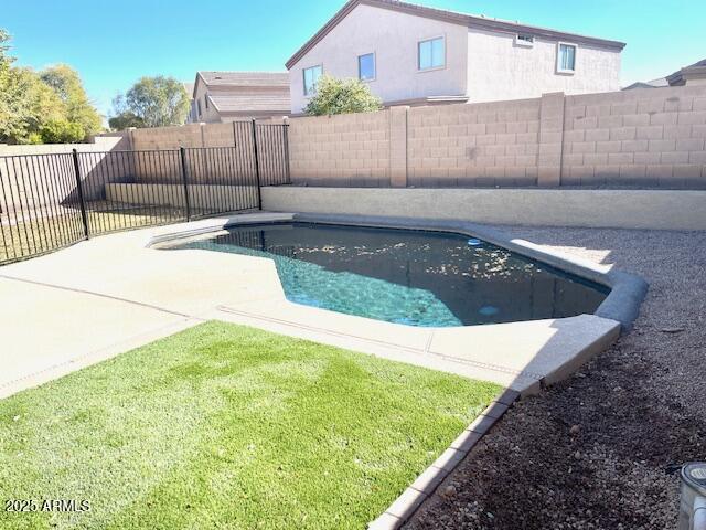 view of swimming pool featuring a lawn, a patio area, a fenced backyard, and a fenced in pool