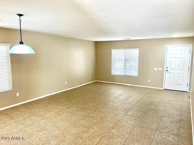 spare room with baseboards