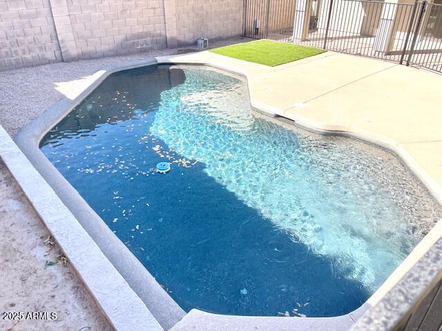 view of pool with a patio area, fence, and a fenced in pool