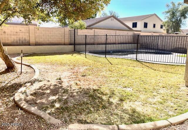 view of yard with a fenced in pool and a fenced backyard