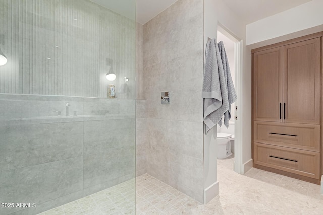 bathroom with tile patterned flooring, toilet, and walk in shower