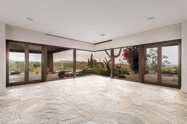 unfurnished sunroom featuring french doors