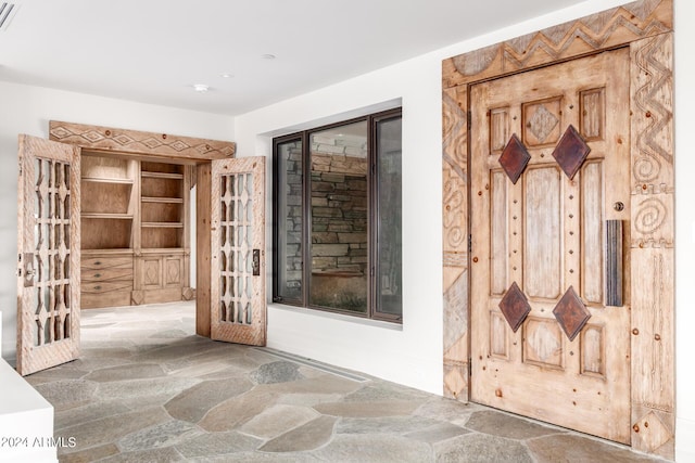 interior space with stone flooring and visible vents