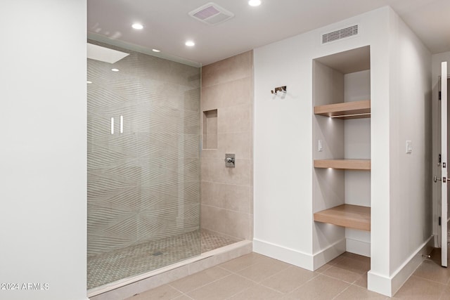 bathroom featuring walk in shower, tile patterned flooring, and visible vents