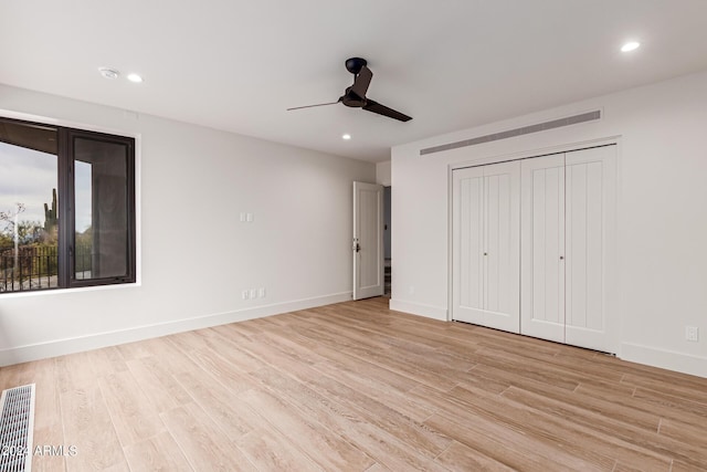 unfurnished bedroom with a closet, ceiling fan, and light hardwood / wood-style flooring