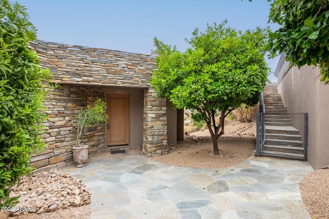 property entrance featuring stone siding