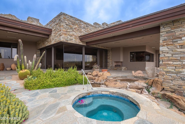 view of pool with a patio area and an in ground hot tub