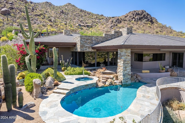 view of swimming pool featuring a mountain view and a patio