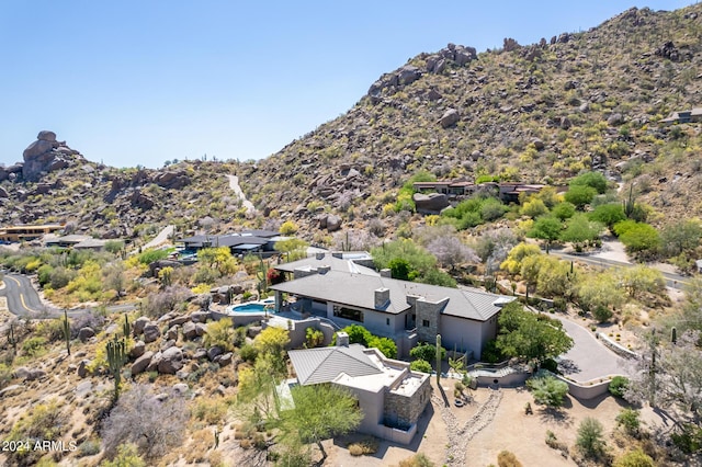 birds eye view of property with a mountain view