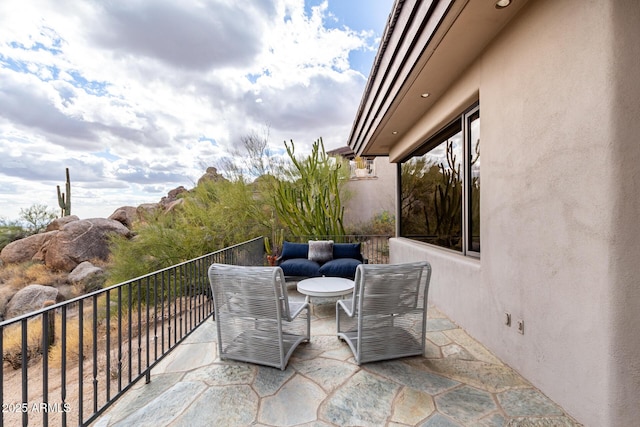 view of patio featuring a balcony