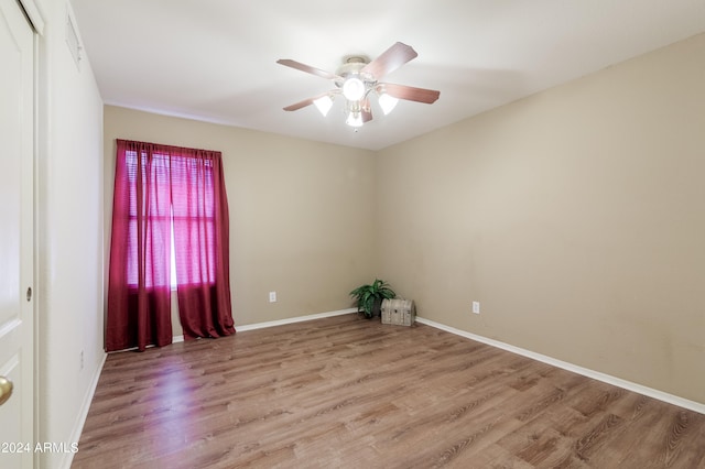 unfurnished room featuring light hardwood / wood-style flooring and ceiling fan