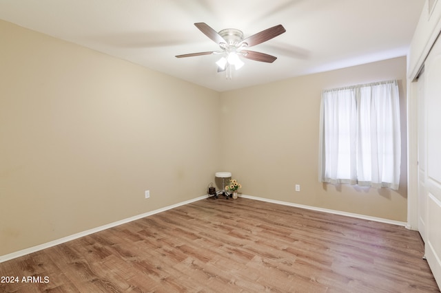 spare room featuring light hardwood / wood-style flooring and ceiling fan