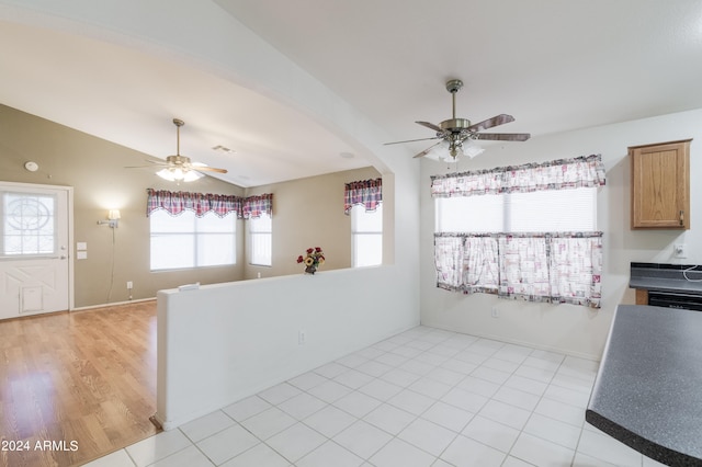 kitchen featuring vaulted ceiling, light wood-type flooring, and ceiling fan