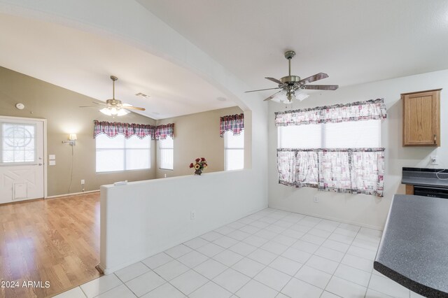 living room with light hardwood / wood-style floors, high vaulted ceiling, and ceiling fan