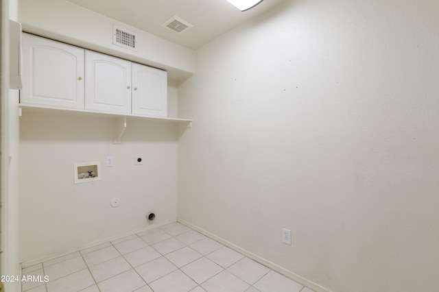 washroom featuring hookup for an electric dryer, light tile patterned flooring, gas dryer hookup, washer hookup, and cabinets