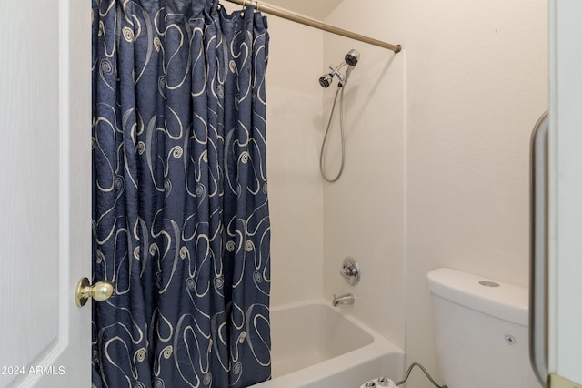 bathroom featuring toilet and shower / bath combo