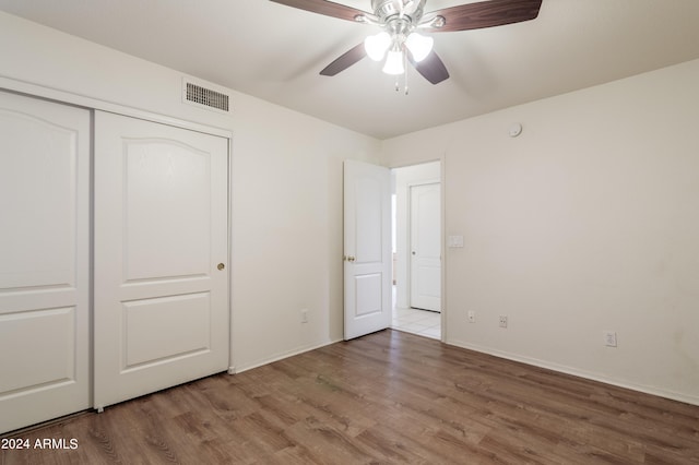 unfurnished bedroom featuring a closet, ceiling fan, and wood-type flooring