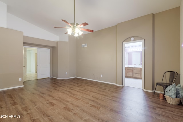 unfurnished living room with hardwood / wood-style flooring, high vaulted ceiling, and ceiling fan