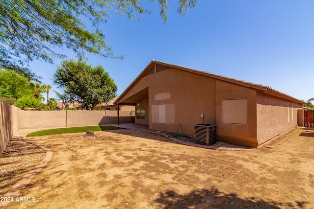 rear view of property with a patio and central AC