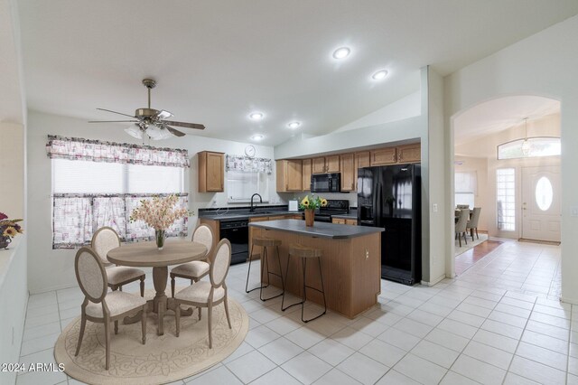 unfurnished living room with a tile fireplace, light wood-type flooring, and ceiling fan