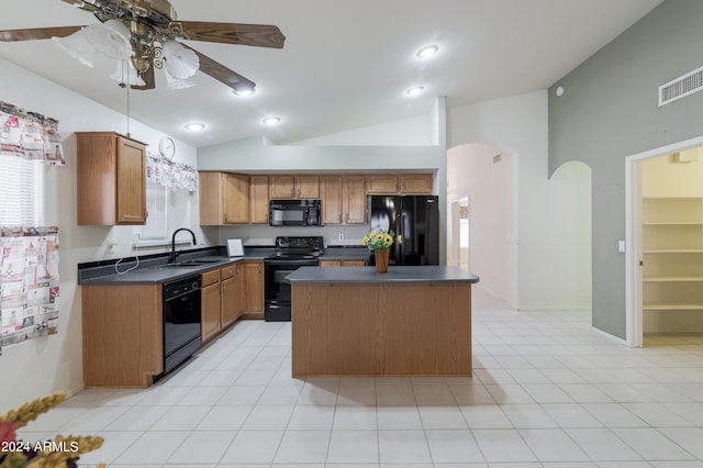 kitchen with lofted ceiling, black appliances, a center island, sink, and ceiling fan