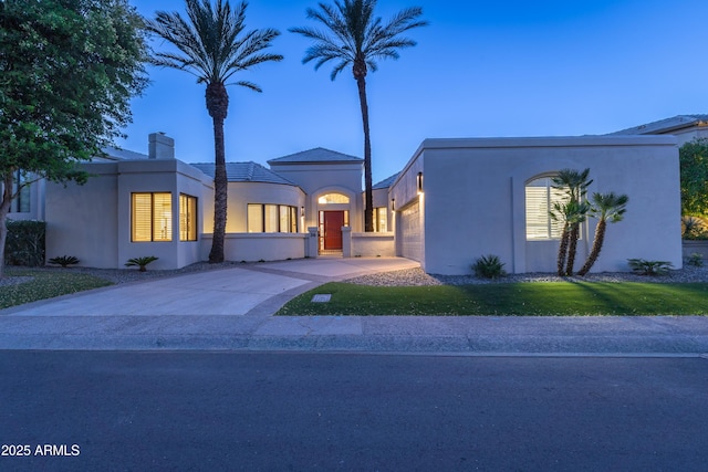 7878 E Gainey Ranch Rd Unit 36, Scottsdale, AZ 85258 - mediterranean / spanish house with an attached garage, stucco siding, concrete driveway, a chimney, and a front yard