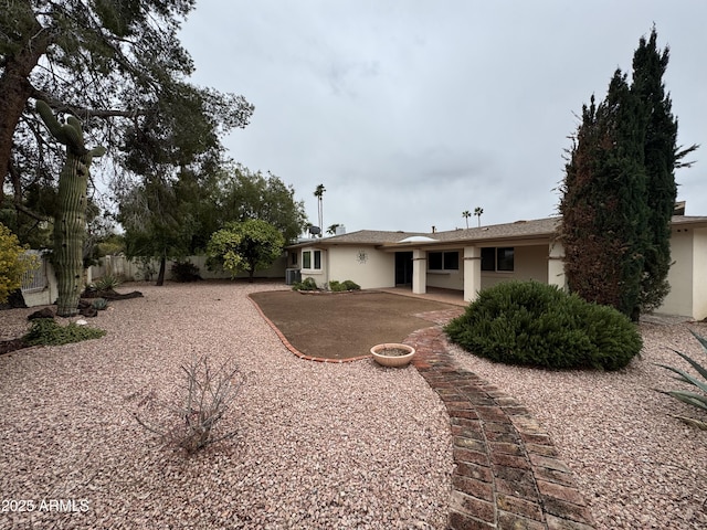 back of property featuring stucco siding, a patio, and fence