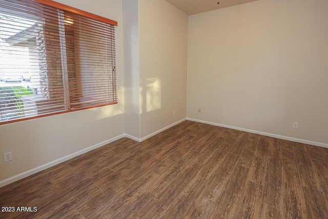 empty room featuring dark hardwood / wood-style flooring