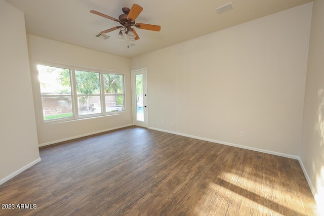 spare room featuring dark hardwood / wood-style flooring and ceiling fan