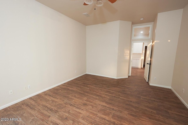 unfurnished room with ceiling fan and dark hardwood / wood-style flooring