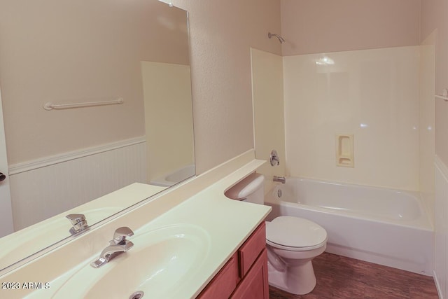 full bathroom with washtub / shower combination, hardwood / wood-style floors, vanity, and toilet