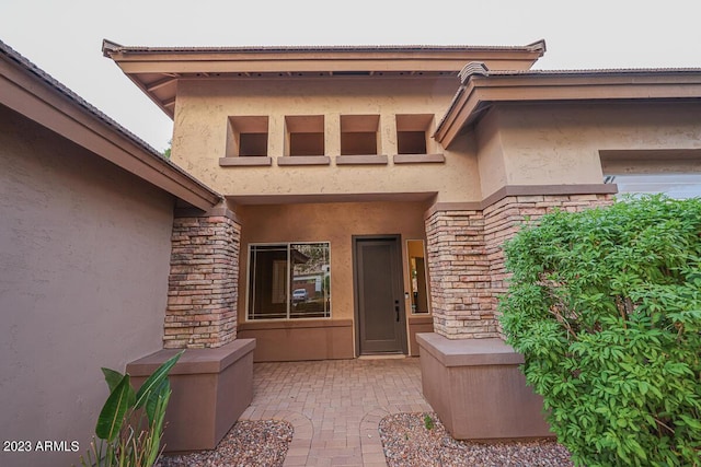 entrance to property featuring a patio