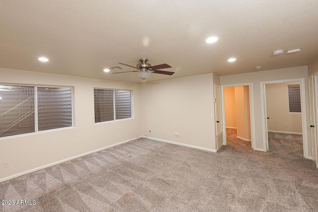 unfurnished room featuring ceiling fan, carpet floors, and a textured ceiling