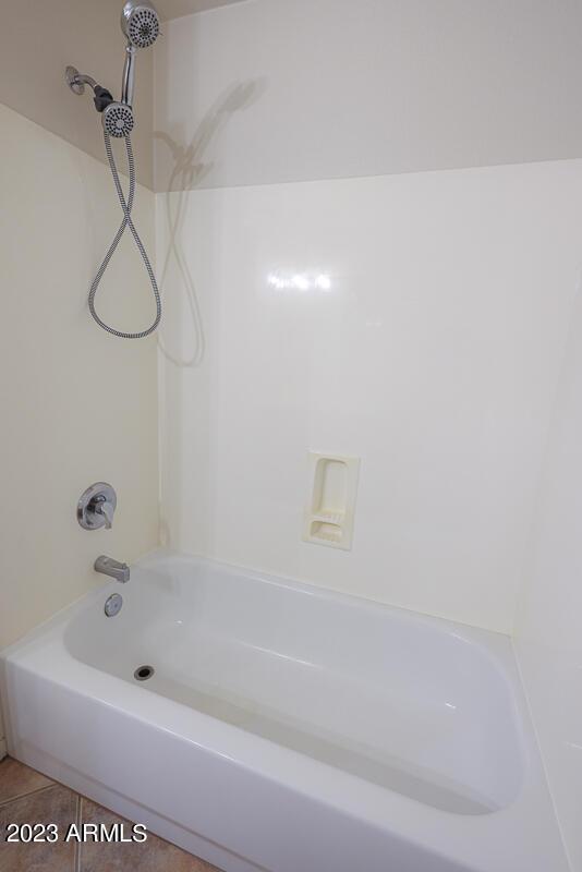 bathroom featuring tile patterned flooring and shower / bathing tub combination