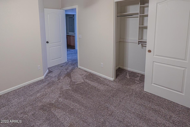 unfurnished bedroom featuring carpet and a closet