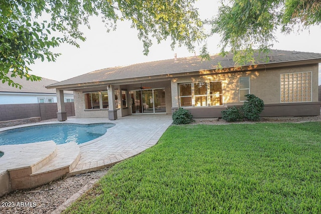 back of house featuring a patio, ceiling fan, and a lawn