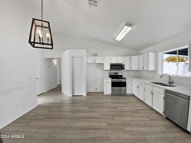 kitchen with pendant lighting, stainless steel appliances, white cabinetry, and sink