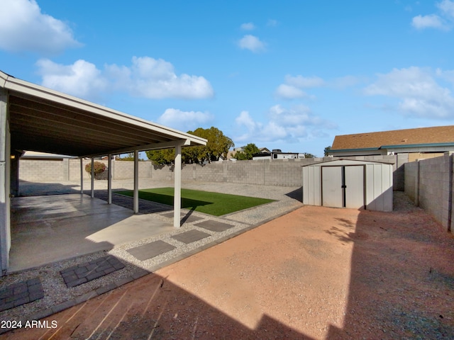 view of yard with a storage unit and a patio area