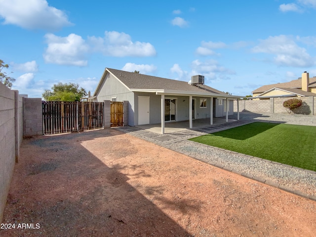 view of front of home with central air condition unit and a patio