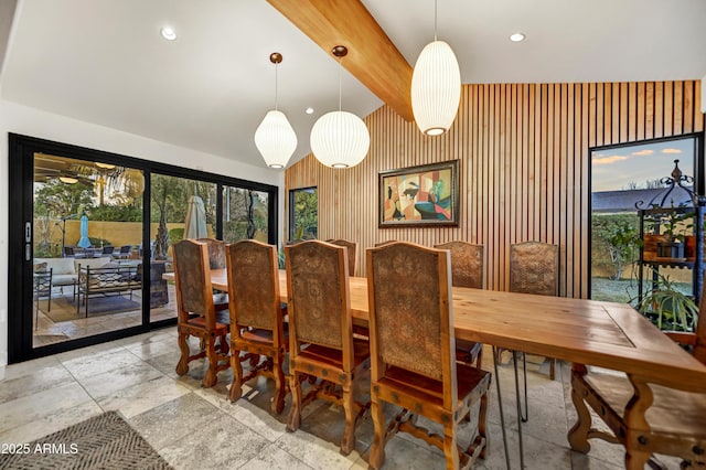 dining room with wood walls