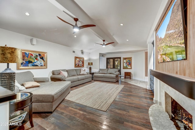 living room featuring a premium fireplace, ceiling fan, dark hardwood / wood-style flooring, and lofted ceiling with beams