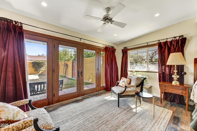 living area with ceiling fan, plenty of natural light, wood-type flooring, and french doors