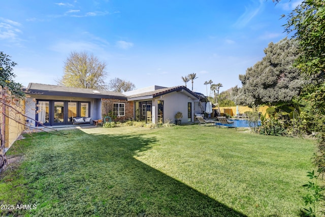 back of house featuring a patio area and a yard