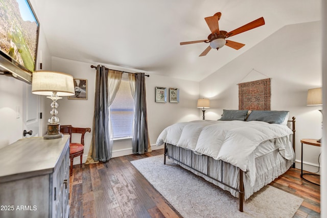 bedroom featuring ceiling fan, dark hardwood / wood-style floors, and lofted ceiling