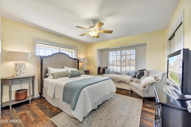 bedroom featuring ceiling fan, a closet, and dark wood-type flooring