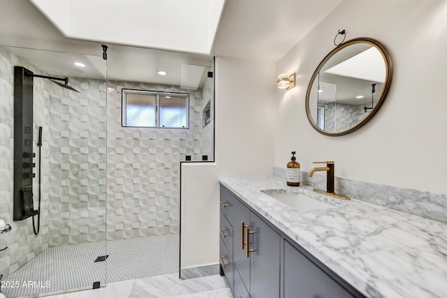 bathroom with vanity and a shower with door