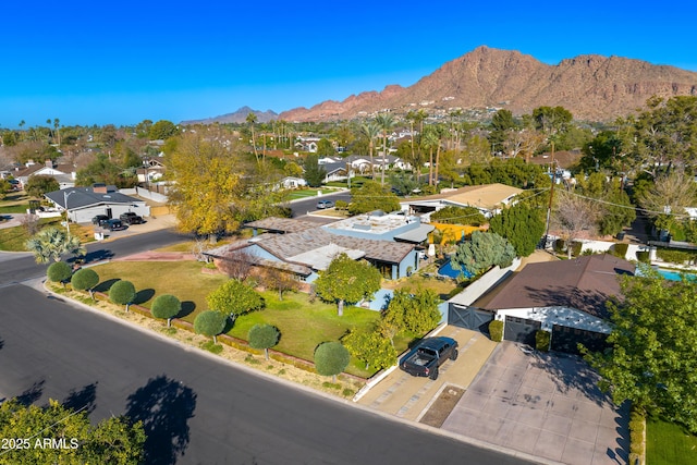 birds eye view of property with a mountain view