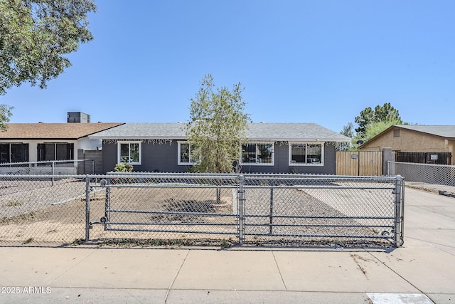 7135 W Flower St, Phoenix, AZ 85033 - single story home with a fenced front yard, concrete driveway, and a gate